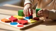 © InfiniteStudio - Child sorts colorful wooden shapes by size and color on a light wooden table in bright natural light Generative AI