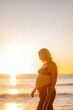 © Austockphoto - expecting mother walking along Manly Beach at sunrise