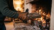 © Letcia - Man wearing leather gloves adds a log to a roaring fireplace for warmth and cozy atmosphere
