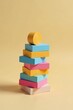 © vattana - A pastel-colored stack of blocks featuring a cylindrical element on top, symbolizing balance and creative construction.