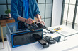 © Charlie's - Computer Technician Repairing Desktop PC Hardware and Troubleshooting Technical Problems in Professional IT Service Workshop.