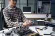 © Charlie's - Male IT Technician Repairing Computer Hardware and Troubleshooting Electronic Components for Modern Technology Maintenance Services