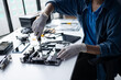 © Charlie's - Male IT Technician Repairing Computer Hardware and Troubleshooting Electronic Components for Modern Technology Maintenance Services
