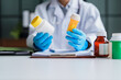 © Charlie's - Doctor Holding Medicine Bottle While Providing Professional Healthcare and Medication Information in Modern Clinic.