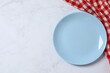 © Sunlight - Blue empty plate with checkered towel on marble background, top view