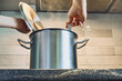 © colnihko - Person stirring broth in steaming pot on kitchen countertop