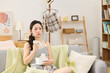 © BuiHong - Sad young woman crying while watching television on a sofa at home