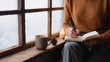 © javu - Cozy holiday activities with journal writing beside snowy window