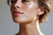 © JoeyMarut - Young woman face angled upward toward sunlight showing smooth glowing skin, defined jawline and neck in soft natural light