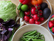 © Yaroslav Danylchenko/Stocksy - Fresh raw vegetables in bowls on wooden table