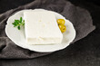© Alesia Berlezova - Feta cheese young, fresh goat brine-cured cheese Greek food healthy eating tasty snack dish fresh, gourmet, rustic food background on the table top view copy space