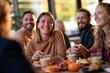 © spyrakot - Colleagues enjoying autumn social event in office lounge with pastries and seasonal decor