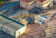 © Amazing Aerial - Aerial view of electrical substation equipment with construction works and a new foundation in Rousset-Serre-Poncon, Provence-Alpes-Cote d'Azur, France.