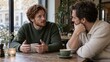 © Len_mik - Two men having a serious conversation over coffee in a cafe. Friends talking about emotions and mental health. Male support and empathy concept