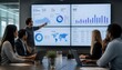 © waheed - Diverse professional team analyzing marketing data on large digital screens in a modern office boardroom