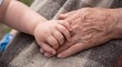 © Candra - Generations Holding Hands Close Up Showing Love and Connection.