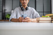 © Charlie's - Student Using Smartphone for Online Education and Internet Research with Artificial Intelligence AI Tools for Learning Research Technology for Everyday Learning.