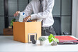 © Charlie's - Businessman Carrying Cardboard Box packing Stuff Resign Depress or carrying business cardboard box Change of job or fired from company resign.