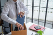 © Charlie's - Businessman Carrying Cardboard Box packing Stuff Resign Depress or carrying business cardboard box Change of job or fired from company resign.