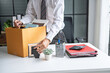 © Charlie's - Businessman Carrying Cardboard Box packing Stuff Resign Depress or carrying business cardboard box Change of job or fired from company resign.