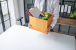 © Charlie's - Businessman Carrying Cardboard Box packing Stuff Resign Depress or carrying business cardboard box Change of job or fired from company resign.