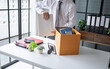 © Charlie's - Businessman Carrying Cardboard Box packing Stuff Resign Depress or carrying business cardboard box Change of job or fired from company resign.