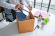© Charlie's - Businessman Carrying Cardboard Box packing Stuff Resign Depress or carrying business cardboard box Change of job or fired from company resign.