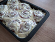 © Marek - Homemade cinnamon buns covered with rich creamy frosting in a baking pan, featuring classic spiral shapes and soft sweet dough, ideal for bakery, dessert, breakfast and home baking concepts.