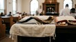 © Sain - Jewish shofar horn rests on white tallit prayer shawl. Traditional ritual objects for Rosh Hashanah, Yom