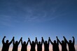 © Generative AI - Silhouetted team holding hands against sunset sky