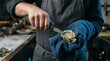 © Creativeraf - Chef shucking fresh raw oyster with a special knife in restaurant kitchen