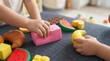 © Nats - Vibrant squishy toys and foam food pieces for kids early learning activity and playroom background.