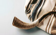 © Jack - A tallit with a shofar symbolizes the Yom Kippur greeting