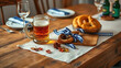 © MOMO - Festive table setting with beer stein and pretzels, autumn celebration concept