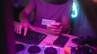 © Krakenimages.com - Man holding creditcard and typing at keyboard in a studio while smiling and looking at screen; gaming purchase focus.