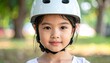 © ณัฐพล ตีระพิมลจันทร์ - portrait of a girl with ephelides wearing a bicycle helmet, serving as a visual reference for phenotypic genetics, pediatric ergonomics, and childhood safety awareness