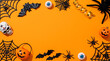 © Creative Shelf - Halloween Flat Lay Frame with Spooky Decor on Orange Background