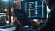 © aqib - Close up of analyst using next-gen blockchain UI on tablet for cyber-fi crypto trading and financial data tracking in dark office room