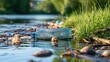© The Little Hut - Plastic bottle floating in polluted river water with natural debris and green grass on bank