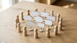 © Jakirul - Wooden figurines surrounding speech bubbles photo representing teamwork communication and discussion on a wooden table