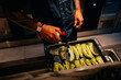 © Maria Sher/Stocksy - Chef Cooking Peppers in Kitchen During Evening