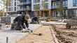 © Serjio - Workers lay pavement stones at a construction site in an urban area during daytime