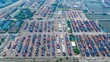 © Amazing Aerial - Aerial view of Jawaharlal Nehru Port Authority with rows of colorful shipping containers, industrial cranes, and logistics infrastructure in Juna Sheva, Maharashtra, India.