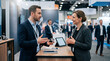 © AmDmLib - Business people talking at trade show booth with tangible experience