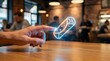 © ties.studio - Hand pointing at holographic burrito hologram in cafe.