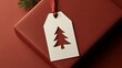 © wilson - Minimalist christmas gift with solid red wrapping paper and off white tag with cut out Christmas tree shape minimalist holiday concept