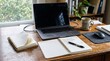 © Sammer - Modern home office workspace with a laptop, open planners for 2026 and 2027, a coffee cup, and a mouse on a wooden desk