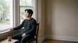 © design - Man Sitting Indoors Looking Out Window Contemplating Life With Coffee Mug Nearby