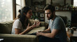 © peno - Young couple intense emotional conversation sitting couch living room woman white top gesturing expressive look bearded man grey t shirt looking down thoughtful scene