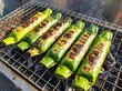 ©  AH Creation - Traditional vietnamese grilled banana cakes wrapped in banana leaves on a metal grate